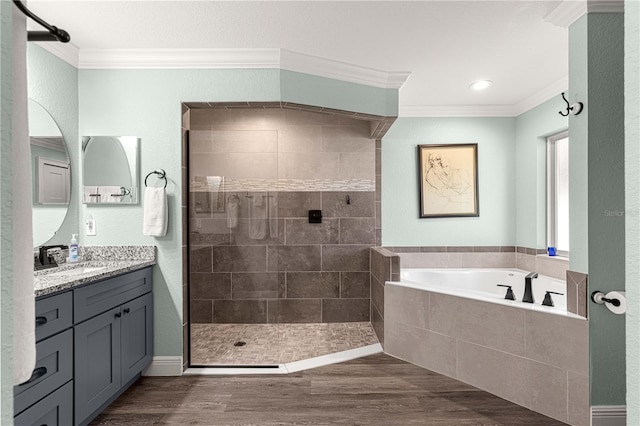 bathroom featuring hardwood / wood-style flooring, vanity, independent shower and bath, and crown molding