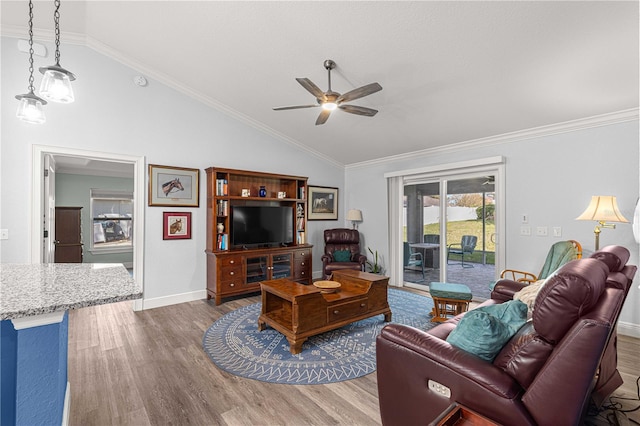 living room featuring ceiling fan, vaulted ceiling, hardwood / wood-style flooring, and ornamental molding