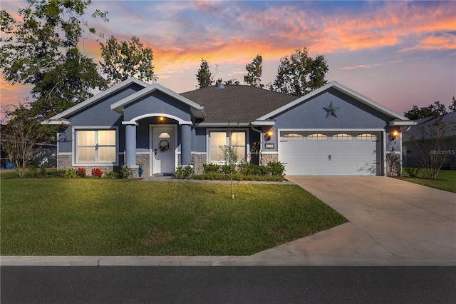 view of front of house with a garage and a lawn