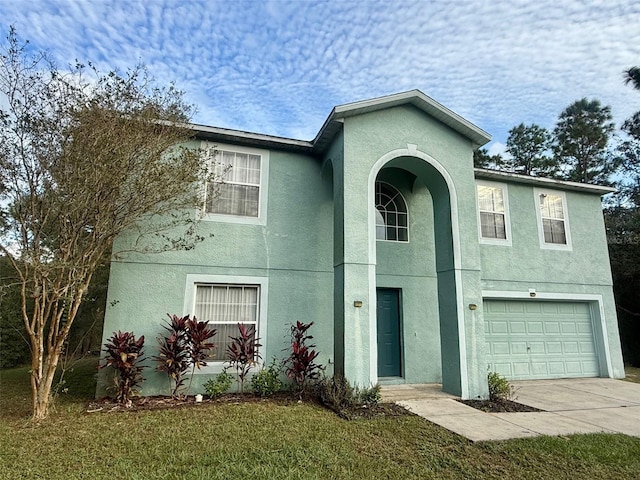 view of front of home with a garage and a front lawn