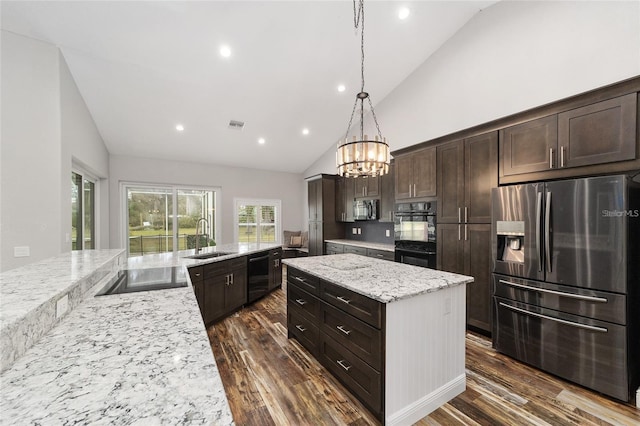 kitchen with dark hardwood / wood-style flooring, black appliances, sink, a kitchen island, and dark brown cabinets