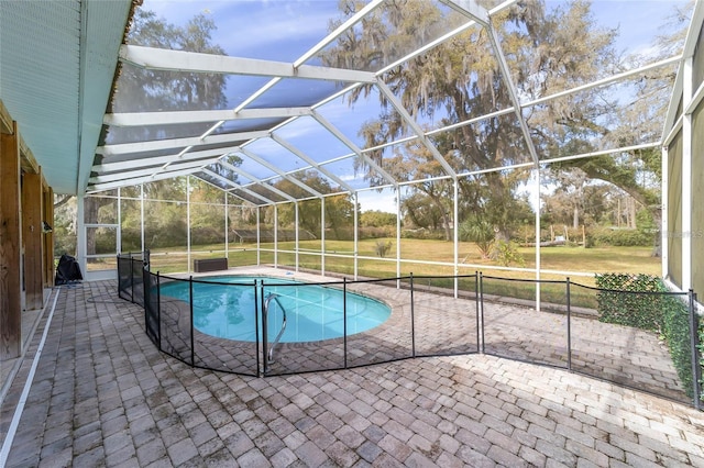 view of pool featuring a lanai, a lawn, and a patio area