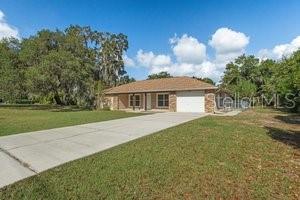 view of front of house with a garage and a front lawn