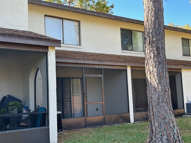 back of house with a sunroom and cooling unit