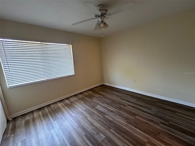 unfurnished room with ceiling fan and dark hardwood / wood-style floors