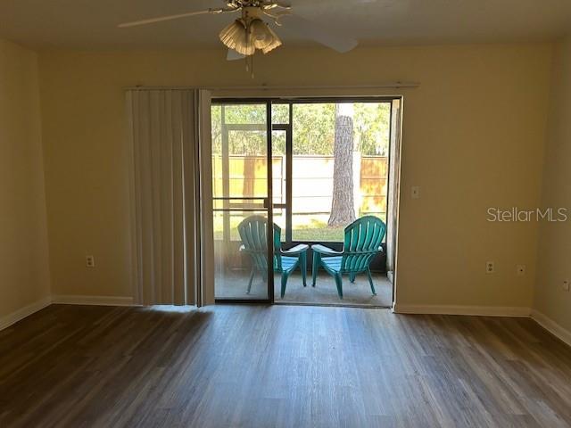 empty room with ceiling fan and wood-type flooring