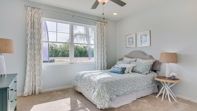 bedroom with light carpet and ceiling fan