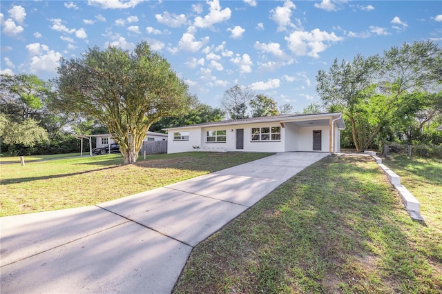 single story home featuring a carport and a front yard