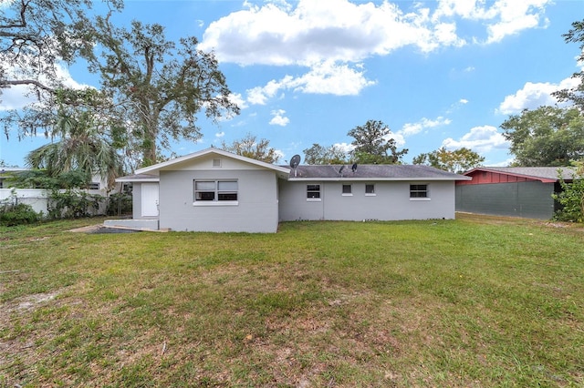 back of house featuring a yard