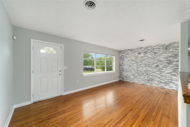 entryway featuring a textured ceiling and hardwood / wood-style flooring