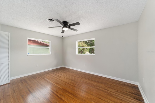 unfurnished room with wood-type flooring, a textured ceiling, and ceiling fan