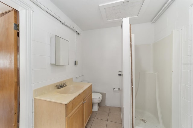 bathroom featuring a shower, tile patterned flooring, vanity, and toilet