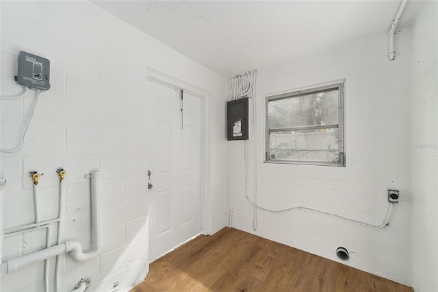 interior space with electric panel and wood-type flooring