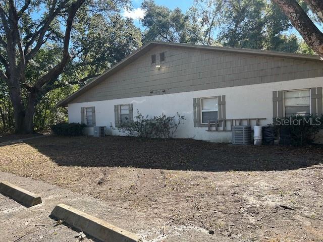 view of side of property featuring central AC