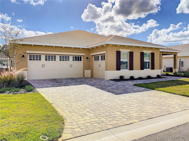 view of front of home with a garage and a front lawn