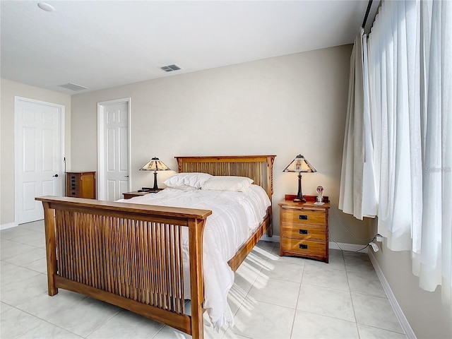 bedroom with light tile patterned floors