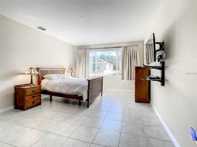 bedroom with light tile patterned floors