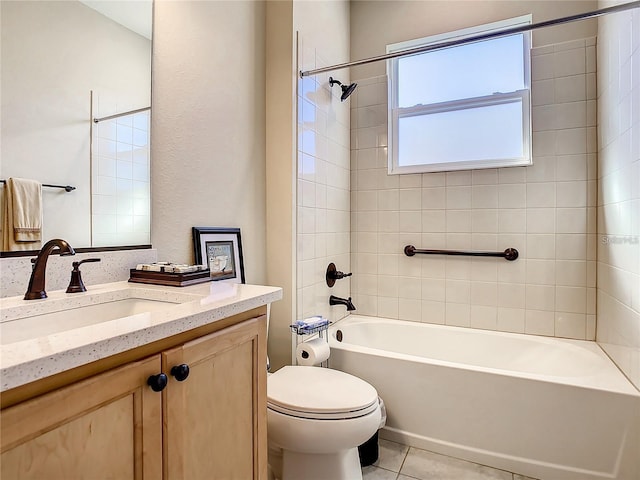 full bathroom with tiled shower / bath, tile patterned floors, toilet, and vanity