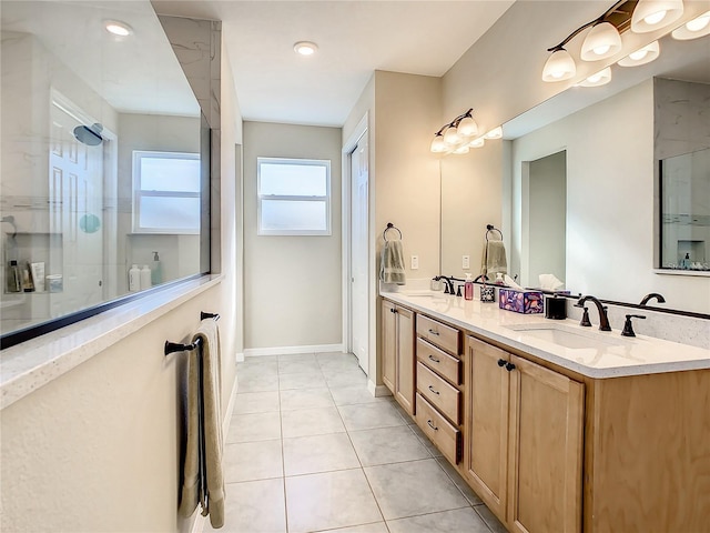 bathroom with vanity, tile patterned floors, and a shower