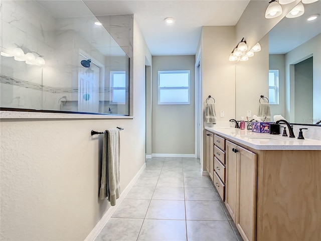 bathroom featuring vanity, tile patterned floors, and a tile shower