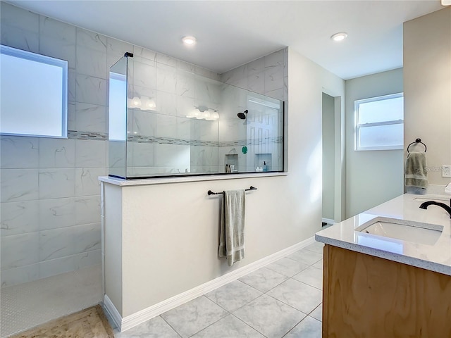 bathroom with vanity, tile patterned floors, and tiled shower