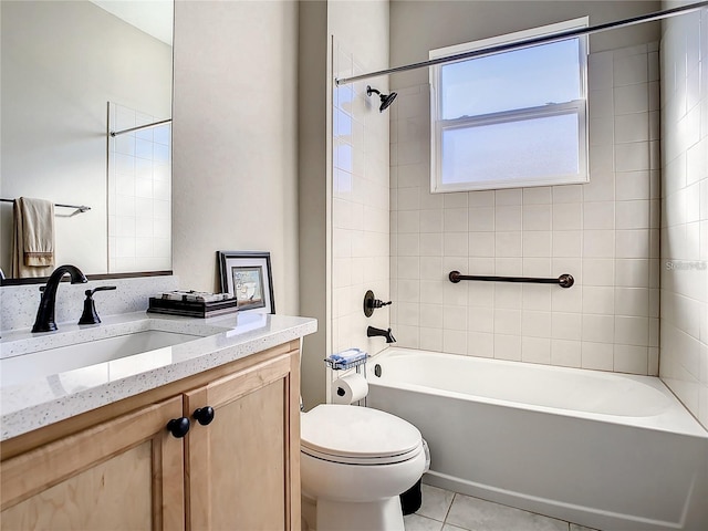 full bathroom featuring tile patterned flooring, vanity, tiled shower / bath combo, and toilet