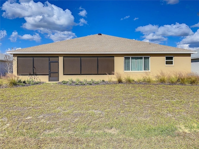 rear view of house featuring a lawn