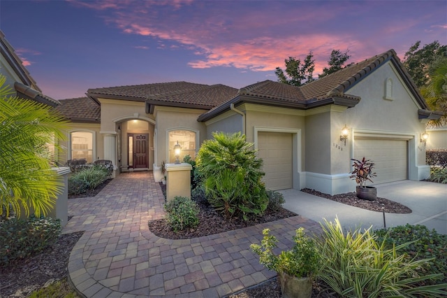 mediterranean / spanish home featuring a garage