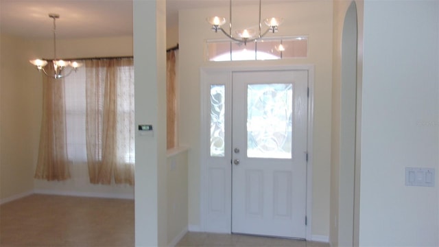 entryway featuring a notable chandelier