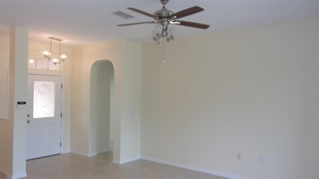 foyer featuring ceiling fan with notable chandelier