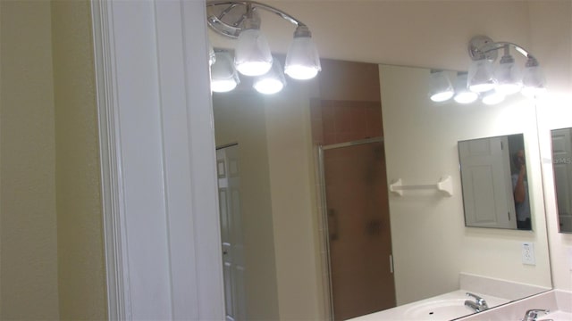 bathroom with vanity and a shower with shower door