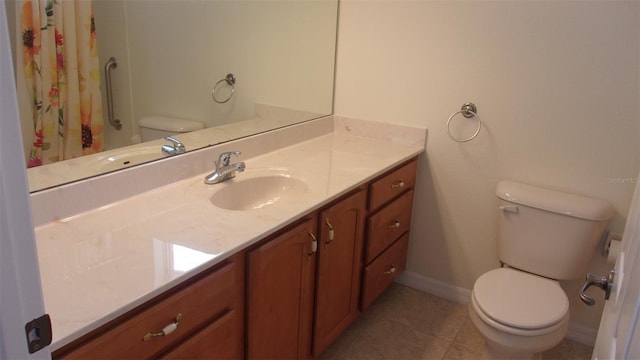 bathroom featuring toilet, vanity, and tile patterned floors