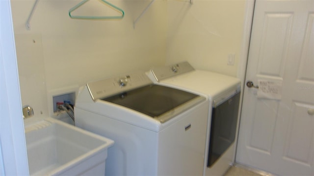 washroom featuring sink and independent washer and dryer