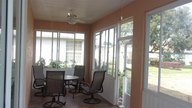 sunroom / solarium featuring ceiling fan