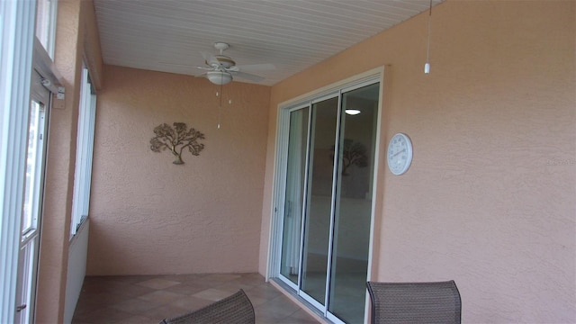 unfurnished sunroom featuring ceiling fan