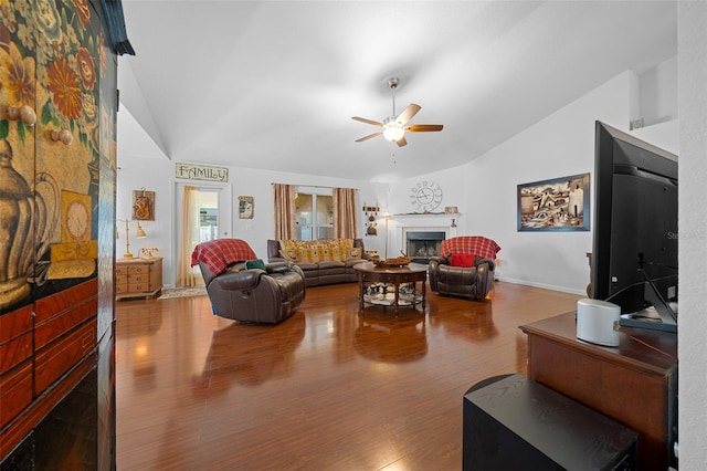 living room with ceiling fan, wood-type flooring, and vaulted ceiling