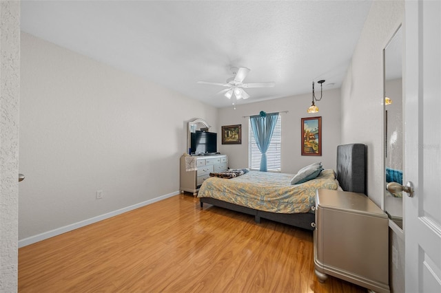 bedroom with light wood-type flooring and ceiling fan