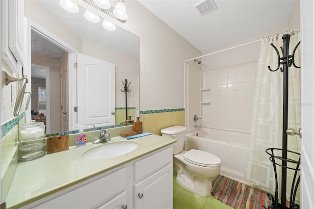 full bathroom featuring tile patterned flooring, shower / bath combo, toilet, and vanity