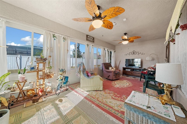 sunroom / solarium featuring ceiling fan