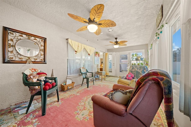 living room with a textured ceiling and ceiling fan