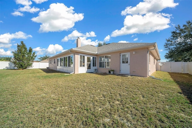 rear view of house with a lawn