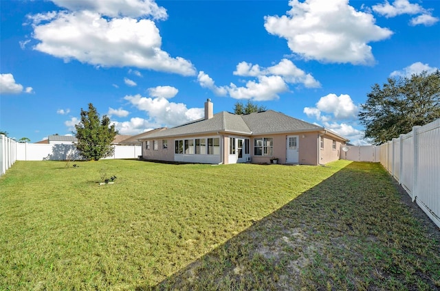 back of house with a yard