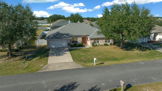 view of front of home with a garage and a front lawn