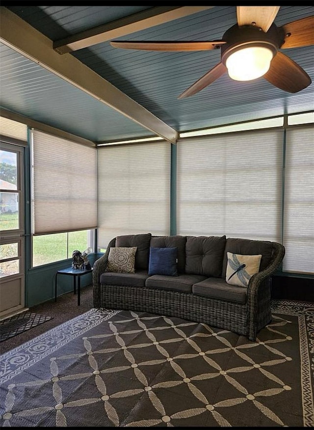 sunroom featuring beam ceiling