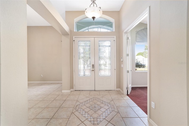 foyer entrance featuring french doors and light tile patterned floors