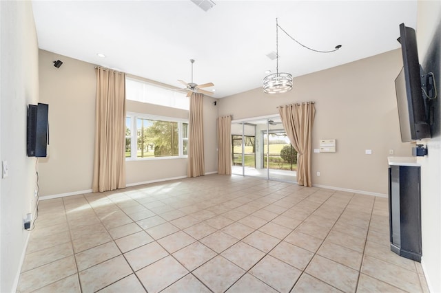 unfurnished living room with light tile patterned flooring and ceiling fan with notable chandelier