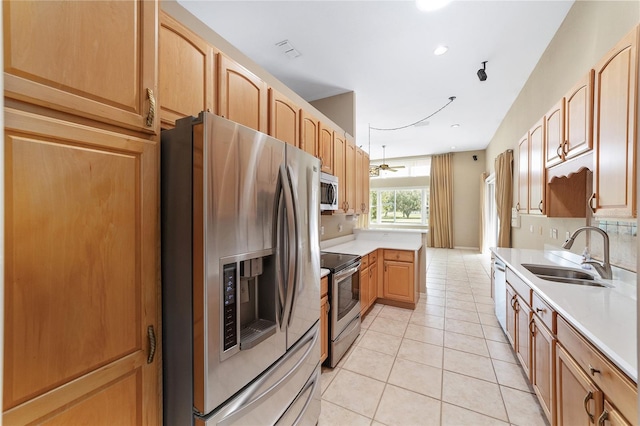 kitchen featuring decorative backsplash, appliances with stainless steel finishes, sink, and light tile patterned flooring