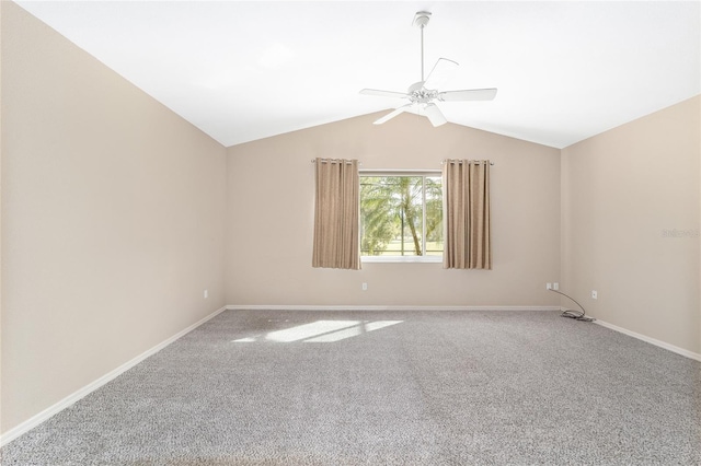 empty room featuring lofted ceiling, carpet flooring, and ceiling fan