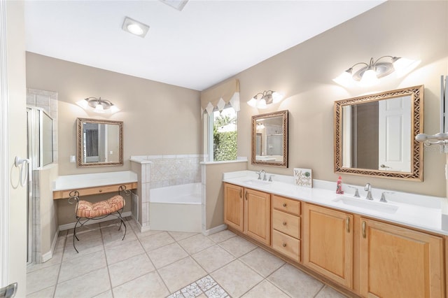 bathroom featuring plus walk in shower, vanity, and tile patterned flooring