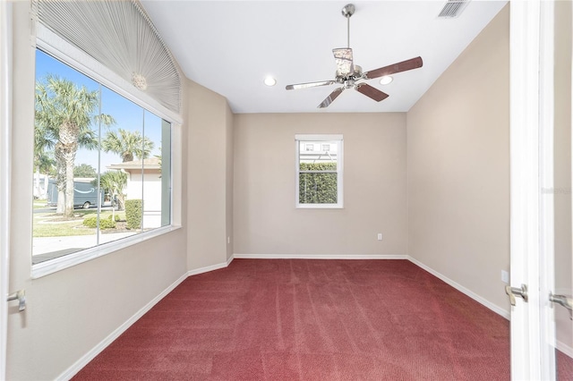 spare room featuring carpet and ceiling fan